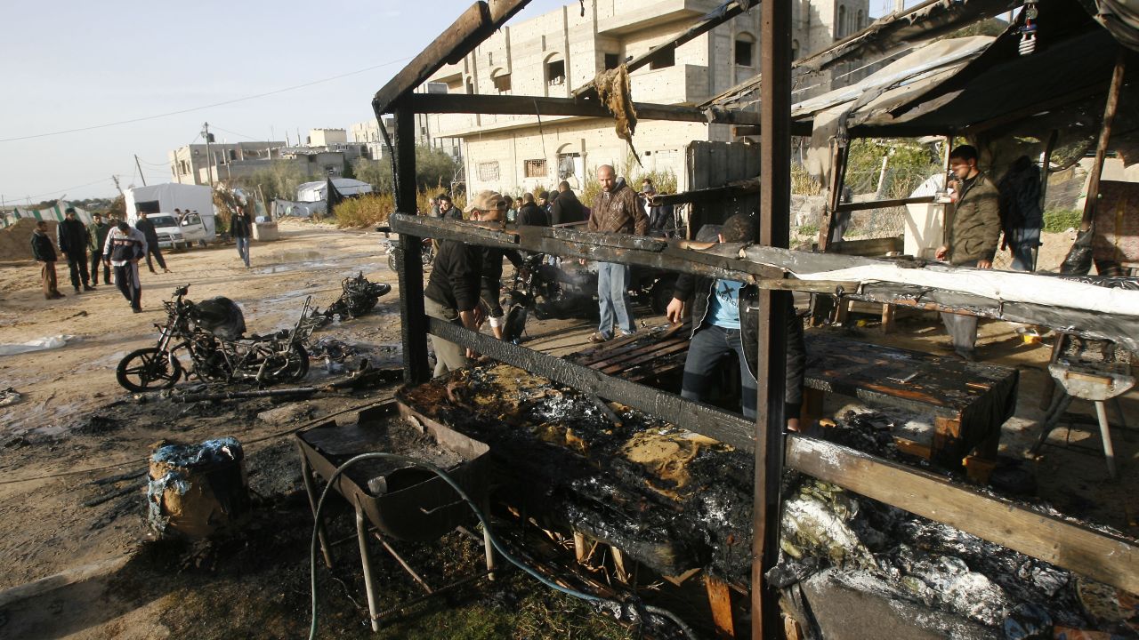 Palestinians inspect the damage at Rafah Refugee Camp after Israeli airstrikes on Saturday.
