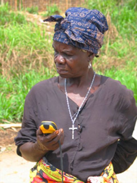 A woman uses a GPS device on a mapping project in the DRC.