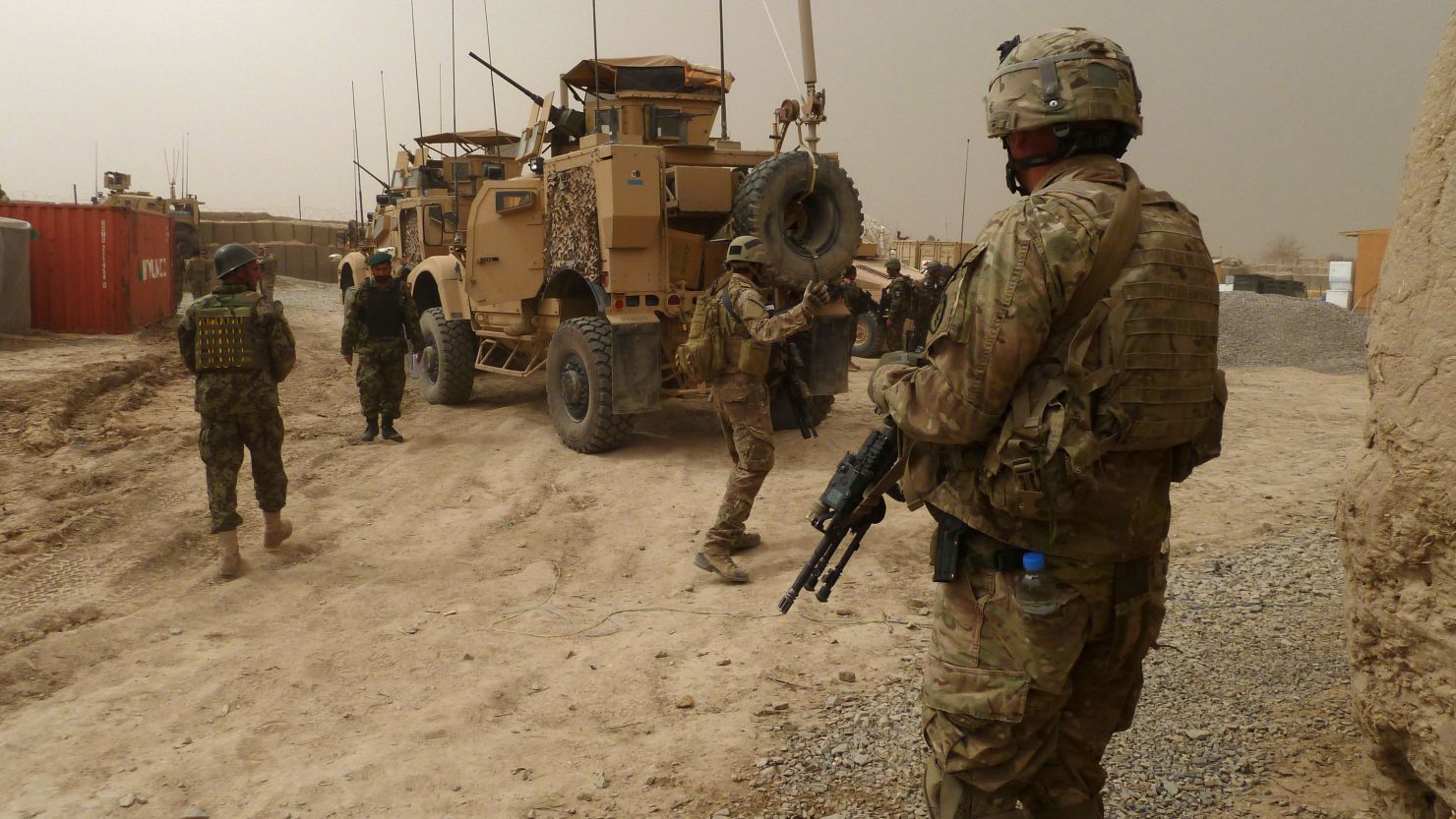 U.S. soldiers keep watch at the entrance of a military base near Alkozai village following the shooting of Afghan civilians allegedly committed by a U.S. soldier in Panjwayi district, Kandahar province on March 11, 2012. 