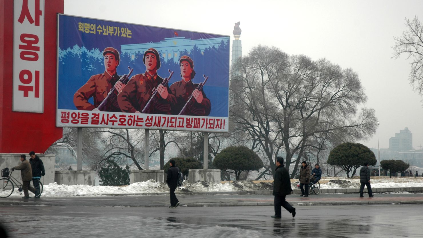 Propaganda billboards tower over passers by in Pyongyang in this image taken in December 2010.