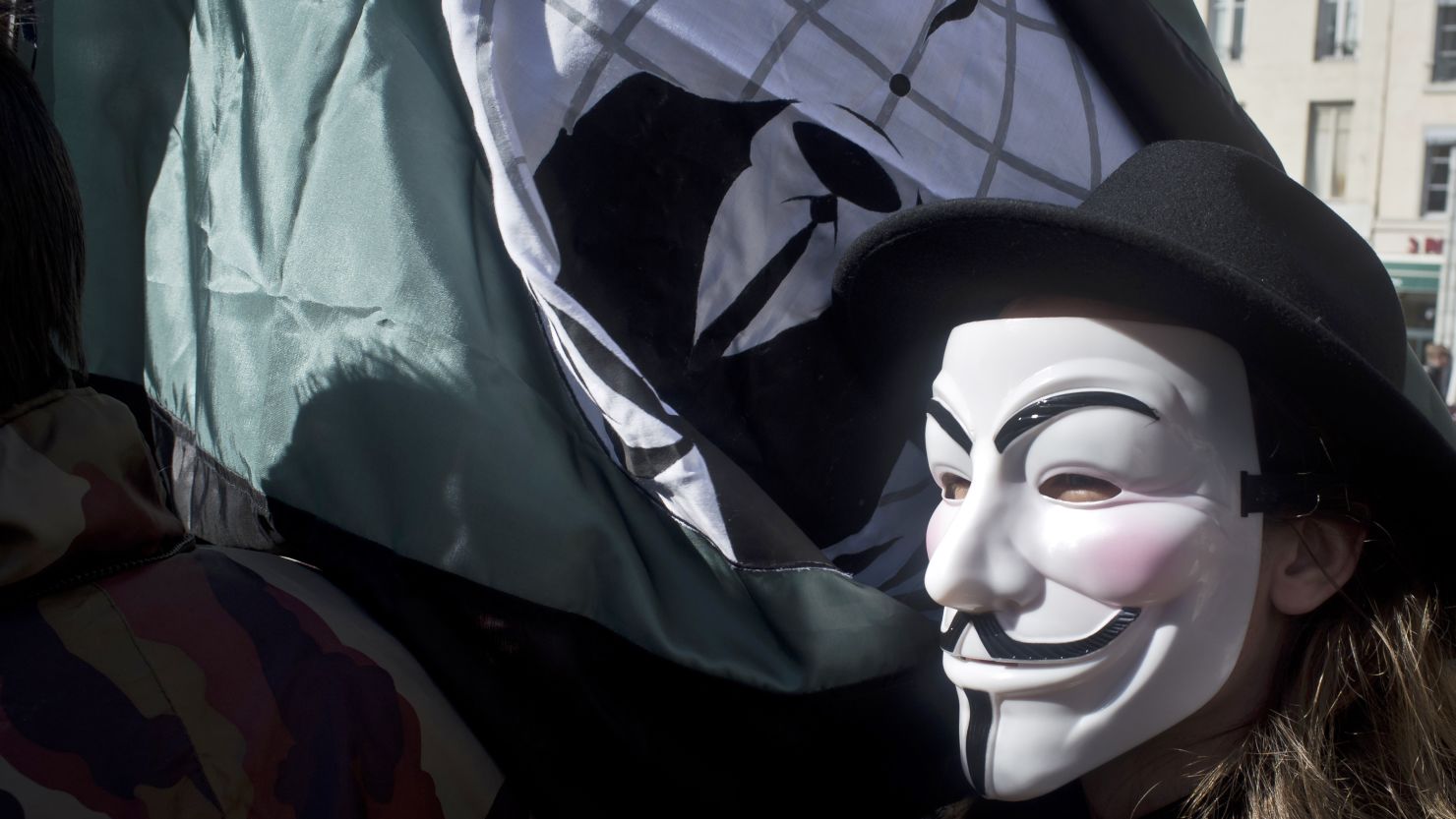 A protester wears an Anonymous mask to a rally in France.