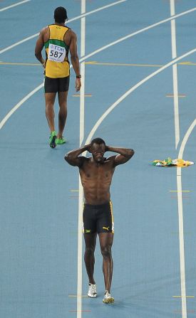Blake's compatriot Usain Bolt was favorite to add the title to his 100m and 200m Olympic crowns, but he was disqualified for a false start. In the background, Blake walks back to the blocks.