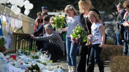 In Lommel, Belgium, children bring flowers in tribute to the victims of the March 13 bus crash.