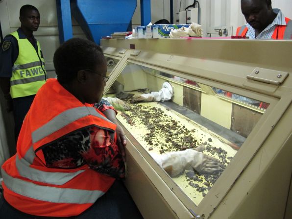 Diamonds are being sorted in a glass case. Marange Resources says no human beings are allowed to touch the diamonds during the extraction process. 