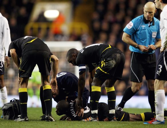 Bolton player Fabrice Muamba  lies prone on the pitch after collapsing before halftime during the English FA Cup quarterfinal away to Tottenham Hotspur on Saturday. 