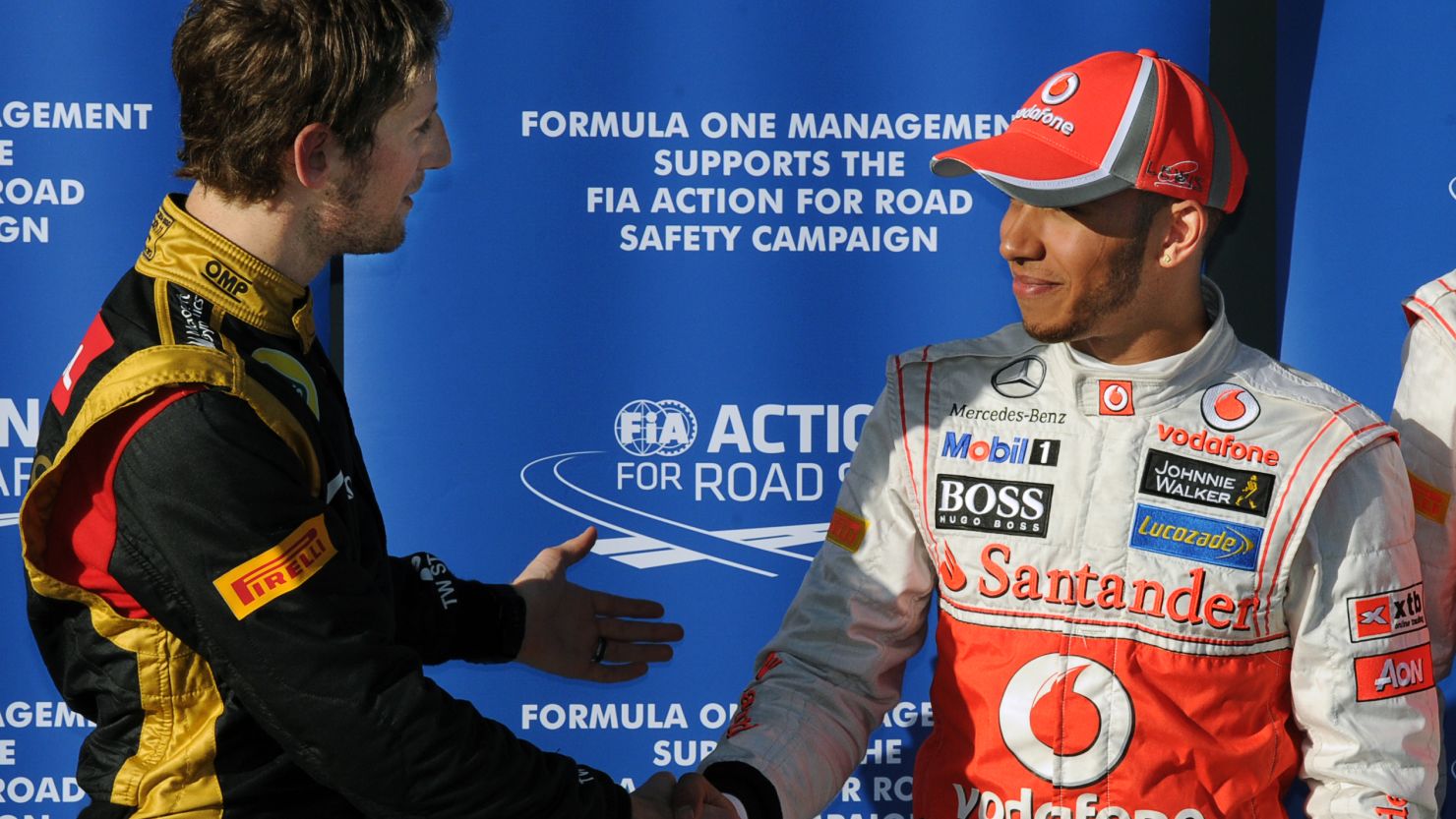 Lotus' Romain Grosjean, left, congratulates Lewis Hamilton after the McLaren driver earns pole position at Albert Park.