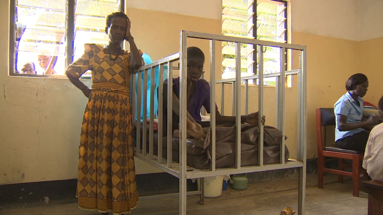 A sufferer of Nodding Disease is put in a child's crib at Antanga Health Center, Uganda, so that he doesn't injure himself. The affliction is associated with violent epilepsy-like convulsions that can lead to permanent disabilities.