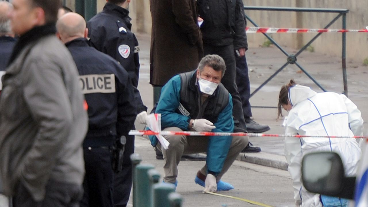 Policemen work near the 'Ozar Hatorah' Jewish school, where four people were killed when a gunman opened fire. 