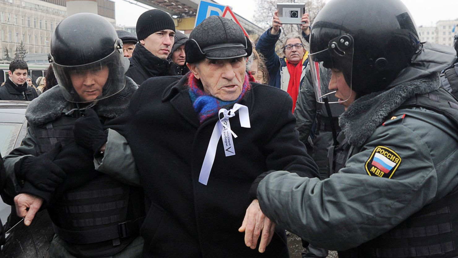 Russian riot policemen detain a protestor during a demonstration outside Ostankino TV Center in Moscow on March 18, 2012.