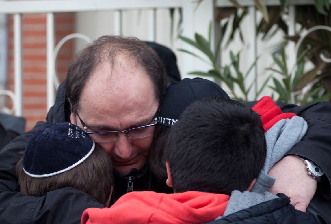 School children are comforted at the scene of the fatal shooting in Toulouse, France on Monday, March 19.