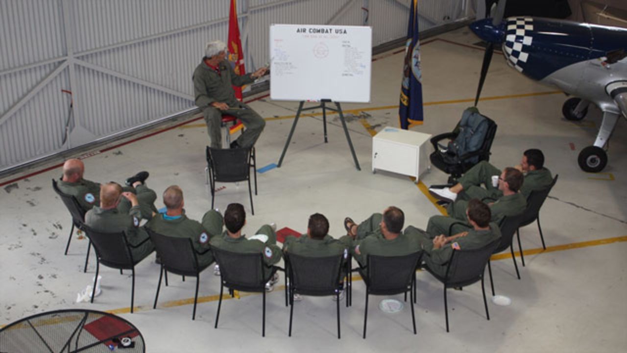 Corporate participants are briefed ahead of taking to the skies for a dogfight.