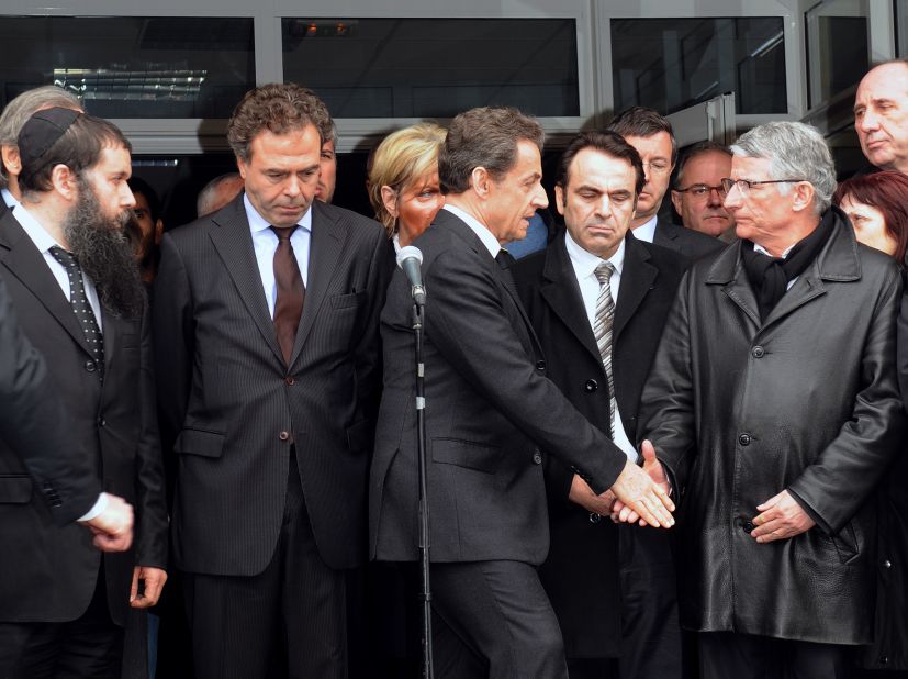 French President Nicolas Sarkozy shakes hands with the mayor of Toulouse at the Ozar Hatorah school. Sarkozy flew to Toulouse on Monday, after the school shooting took place. He declared "everything must be done so the killer is arrested."