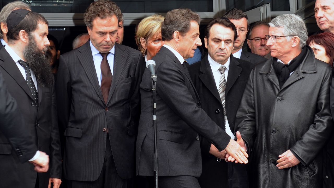 France's Pres. Nicolas Sarkozy (C), shakes hands with the mayor of Toulouse at the 'Ozar Hatorah' Jewish school.