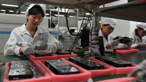 Workers inspect motherboards on a factory line at the Foxconn plant in Shenzen on May 26, 2010. 