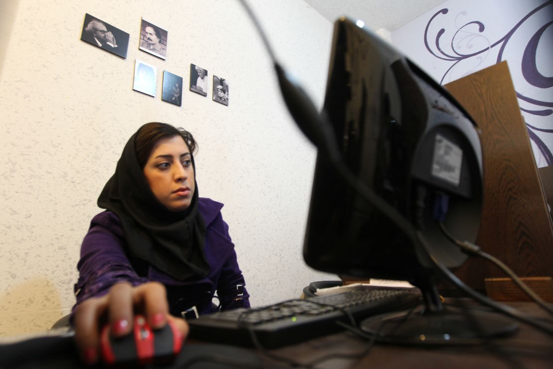 An Iranian woman surfs the internet at a cyber cafe in central Tehrah.