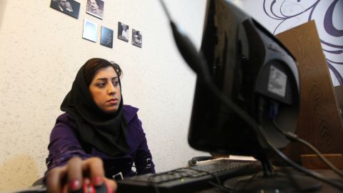  An Iranian woman surfs the internet at a cyber cafe in central Tehrah.