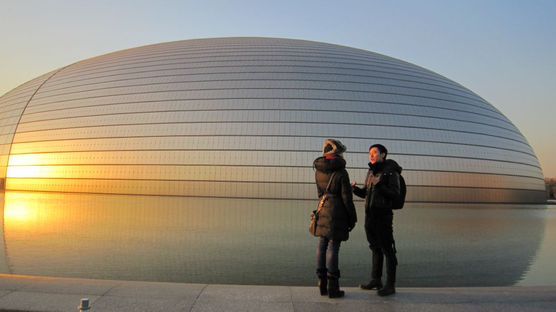 Rojo went on a "Fusion Journey" to Beijing. Chinese choreographer Fei Bo accompanied Rojo on a tour of some of Beijing's cultural focal points. Here, they are seen as the sun sets behind the enormous National Centre for the Performing Arts.