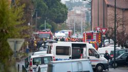 Police and members of the emergency services surround a shooting suspect's home in Toulouse.
