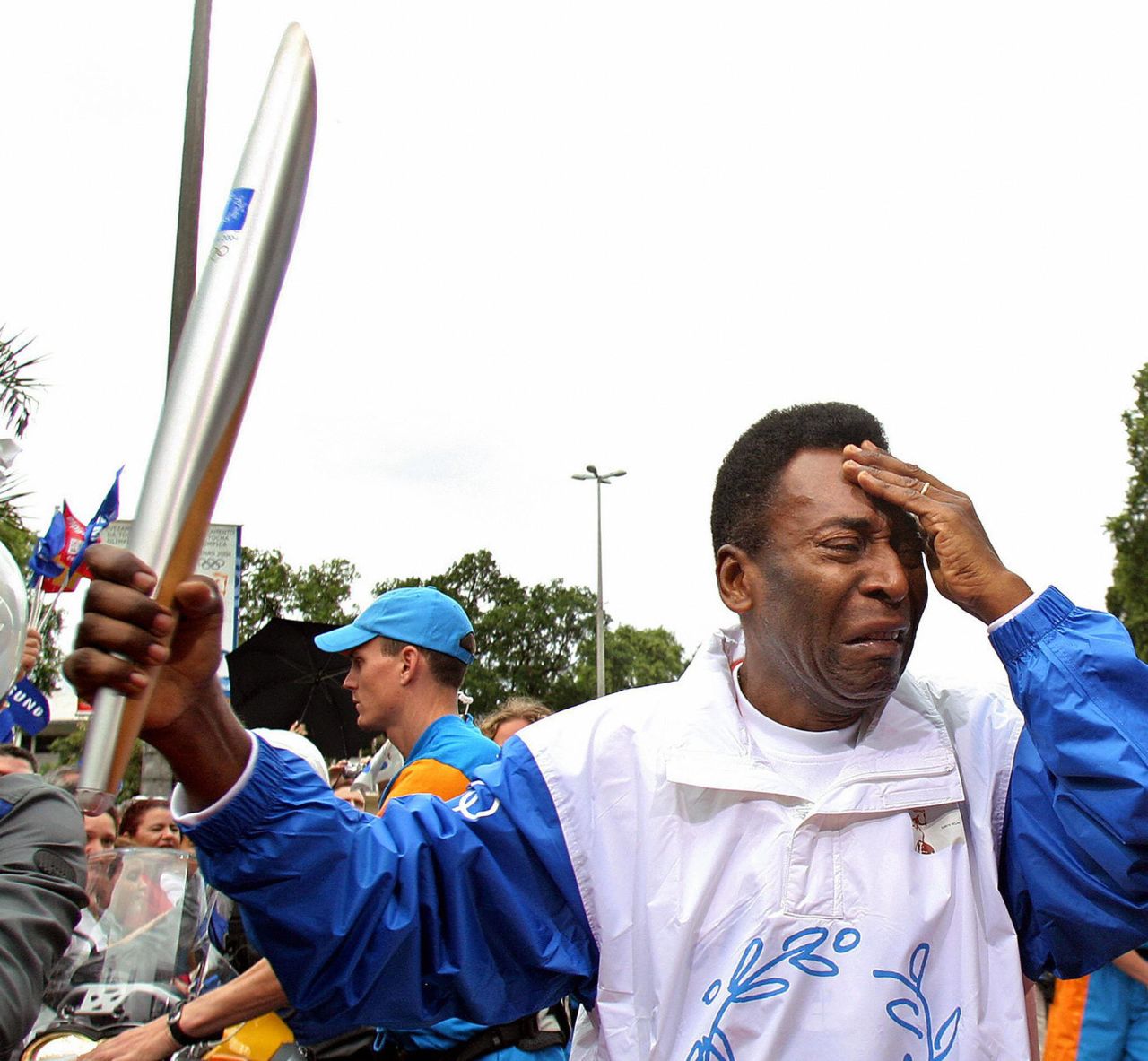 Brazil football legend Pele sheds tears as he carries the torch for the 2008 Beijing Olympics on its visit to Rio. Brazil will host the Summer Games in 2016.