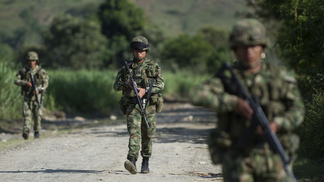 Colombian soldiers patrol along a dirt road in Miranda, Colombia, on January 18, 2012. 