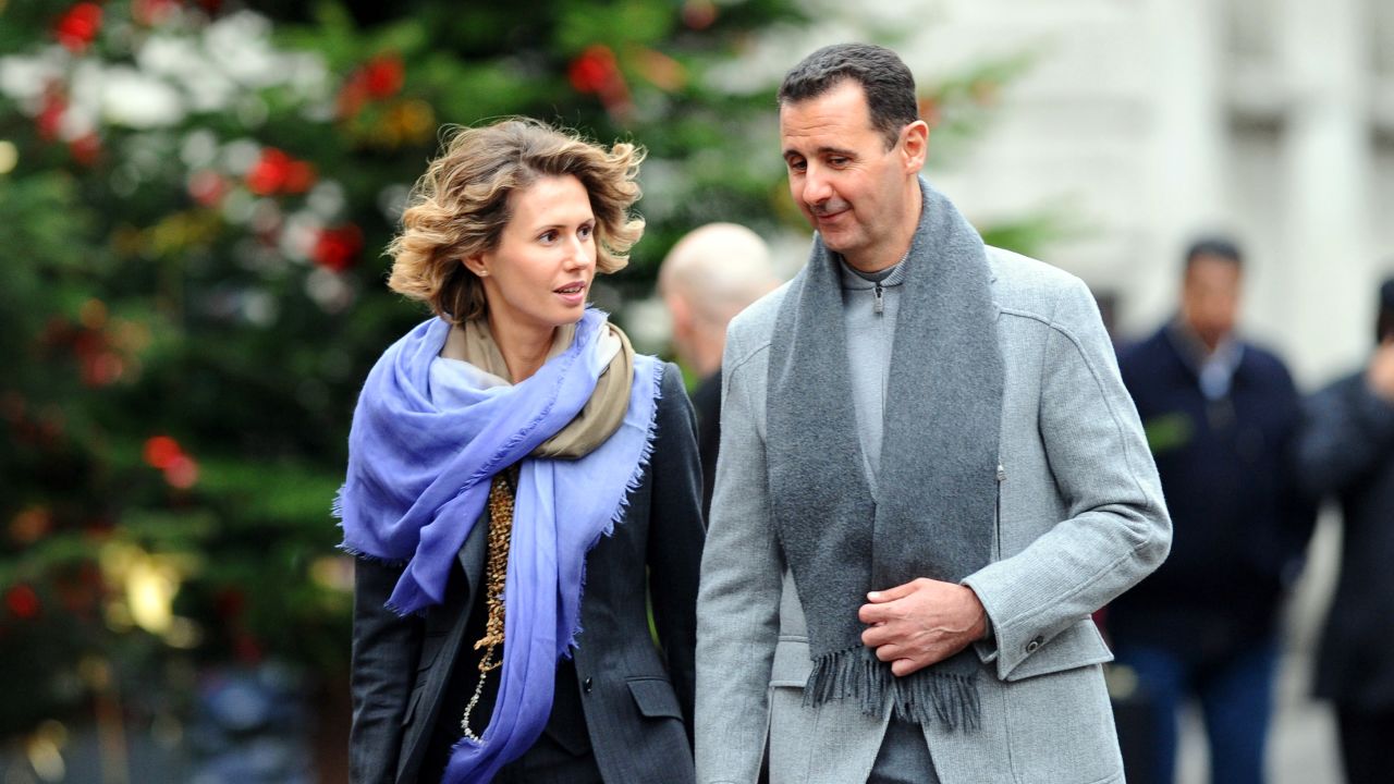 Syrian President Bashar al-Assad and his wife, Asma, walk along a Paris street in 2010. The couple share flirtatious e-mails.