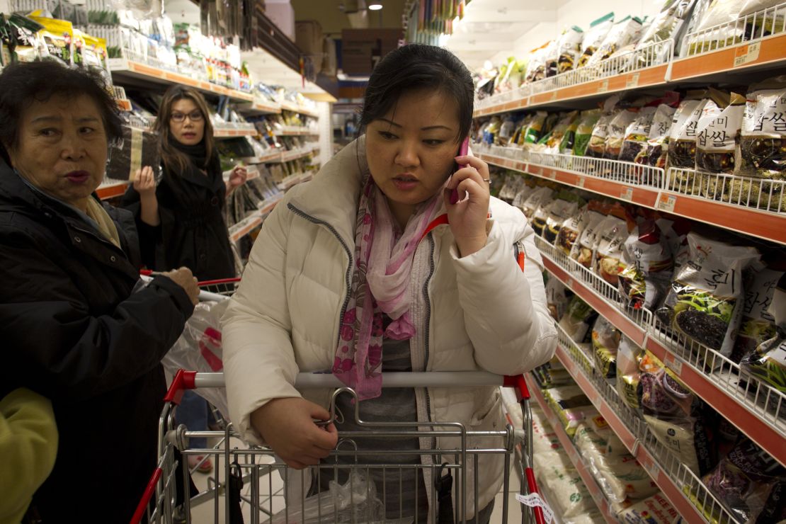 JinHye Han talks on her cell phone as she looks through the aisles at the local Korean grocery. 