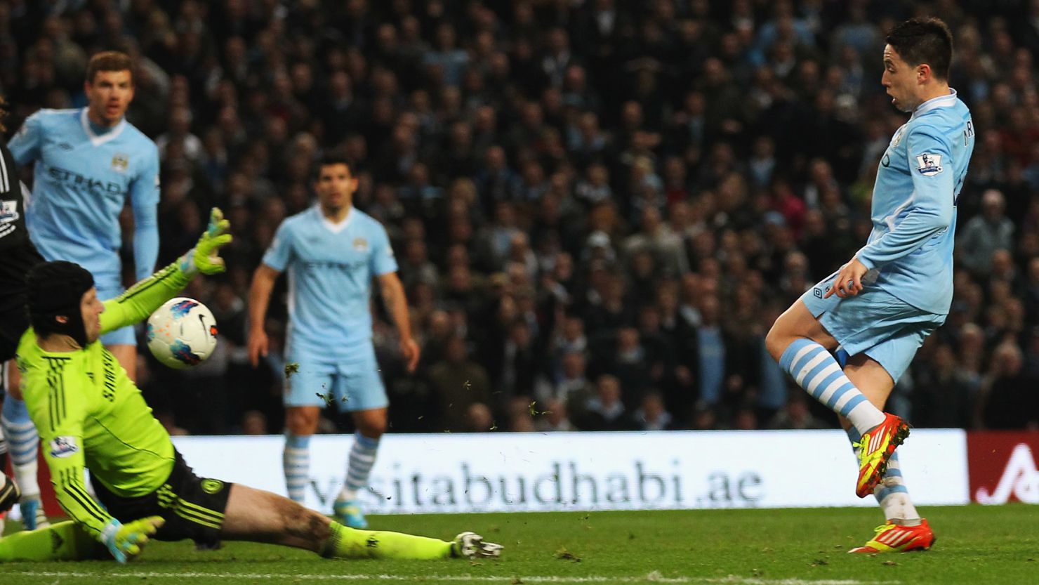 Samir Nasri lifts the ball over Chelsea keeper Petr Cech to seal a dramatic win for Manchester City