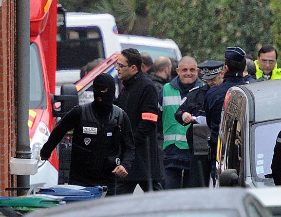 French policemen stand near the apartment of Mohammed Merah on Wednesday. Interior Minister Gueant said the suspect was a French national of Algerian origin.