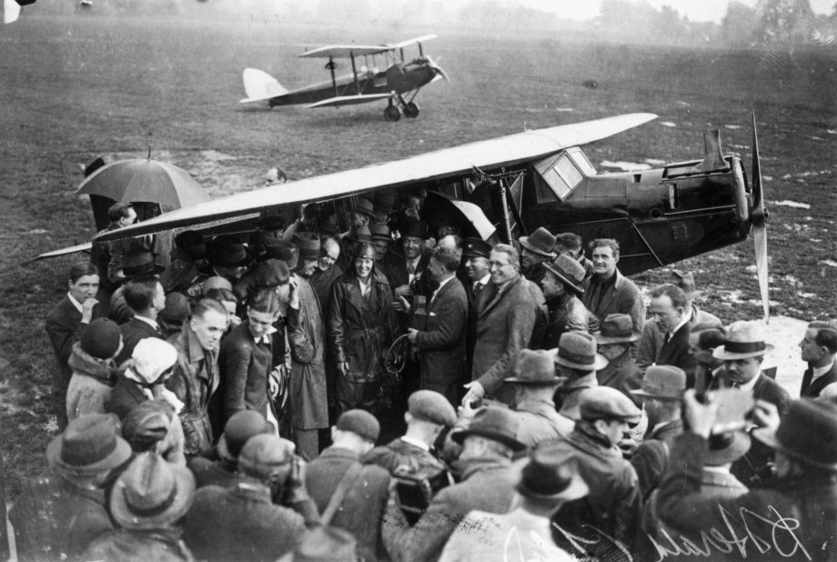 Amelia Earhart is surrounded by well-wishers after completing the first solo transatlantic flight by a woman, landing in Northern Ireland in 1932.