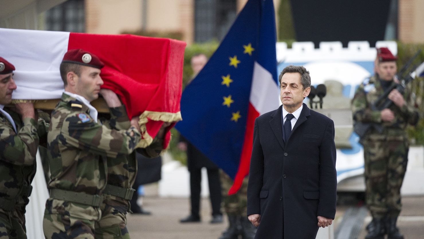 French President Nicolas Sarkozy looks on as soldiers carry the coffin of a French paratrooper killed by the Toulouse gunman.