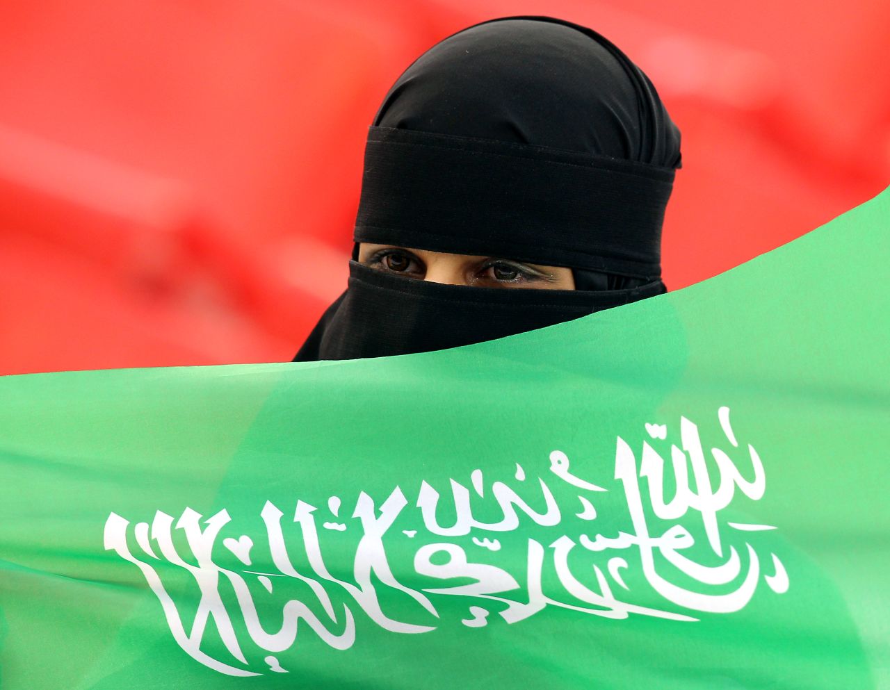 A Saudi football fan cheers for her team before the start of the Asian Cup Group B match against Jordan in January 2011. 