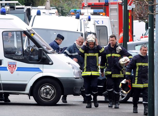 Police and rescue members are pictured after the siege ends on Thursday. Police burst into the apartment of Mohammed Merah, prompting a shootout that ended with Merah, gun in hand, jumping out a window to his death, authorities said Thursday.