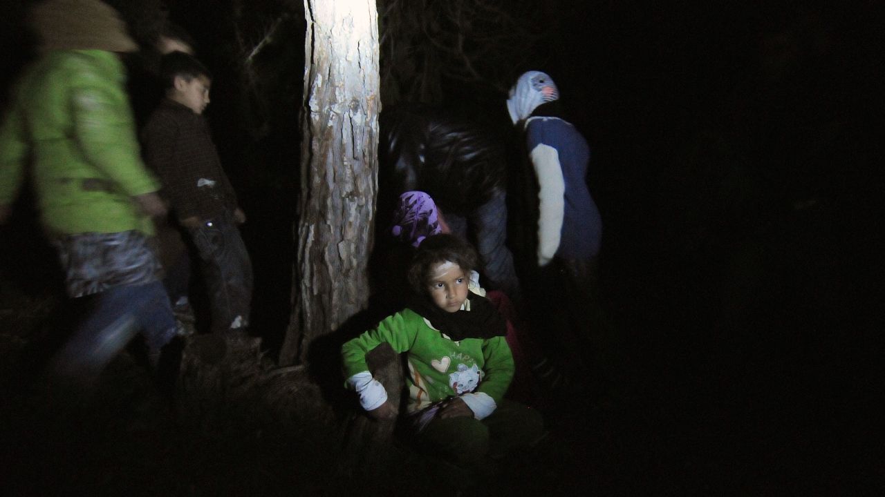 A Syrian boy escapes at night with his family from their hiding place, making for the Turkish border.
