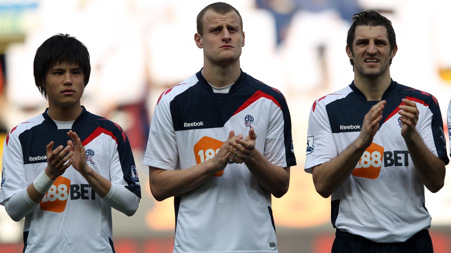 Bolton players including goalscorer David Wheater (center) in a minute's applause for Fabrice Muamba.