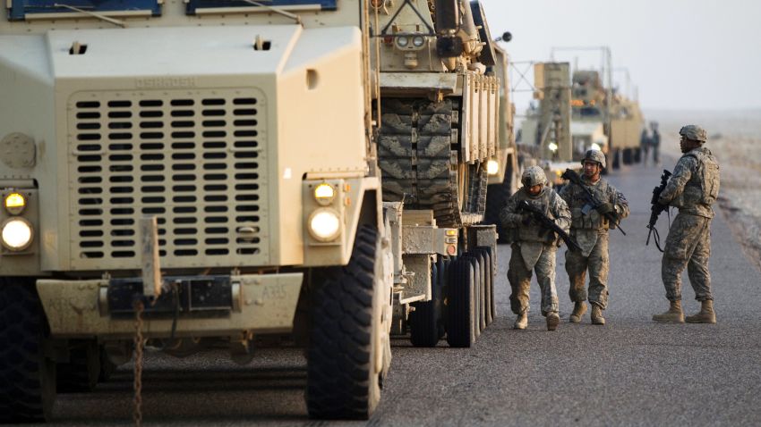 NASIRIYAH, IRAQ - DECEMBER 18: Soldiers with the 3rd Brigade Combat Team, 1st Cavalry Division perform a security check on their Mine Resistant Ambush Protected (MRAP) vehicles near the Kuwaiti border as part of the last U.S. military convoy to leave Iraq on December 18, 2011 near Nasiriyah, Iraq. All U.S. troops were scheduled to have departed Iraq by December 31st, 2011. At least 4,485 U.S. military personnel died in service in Iraq. According to the Iraq Body Count, more than 100,000 Iraqi civilians have died from war-related violence. (Photo by Lucas Jackson - Pool/Getty Images) 