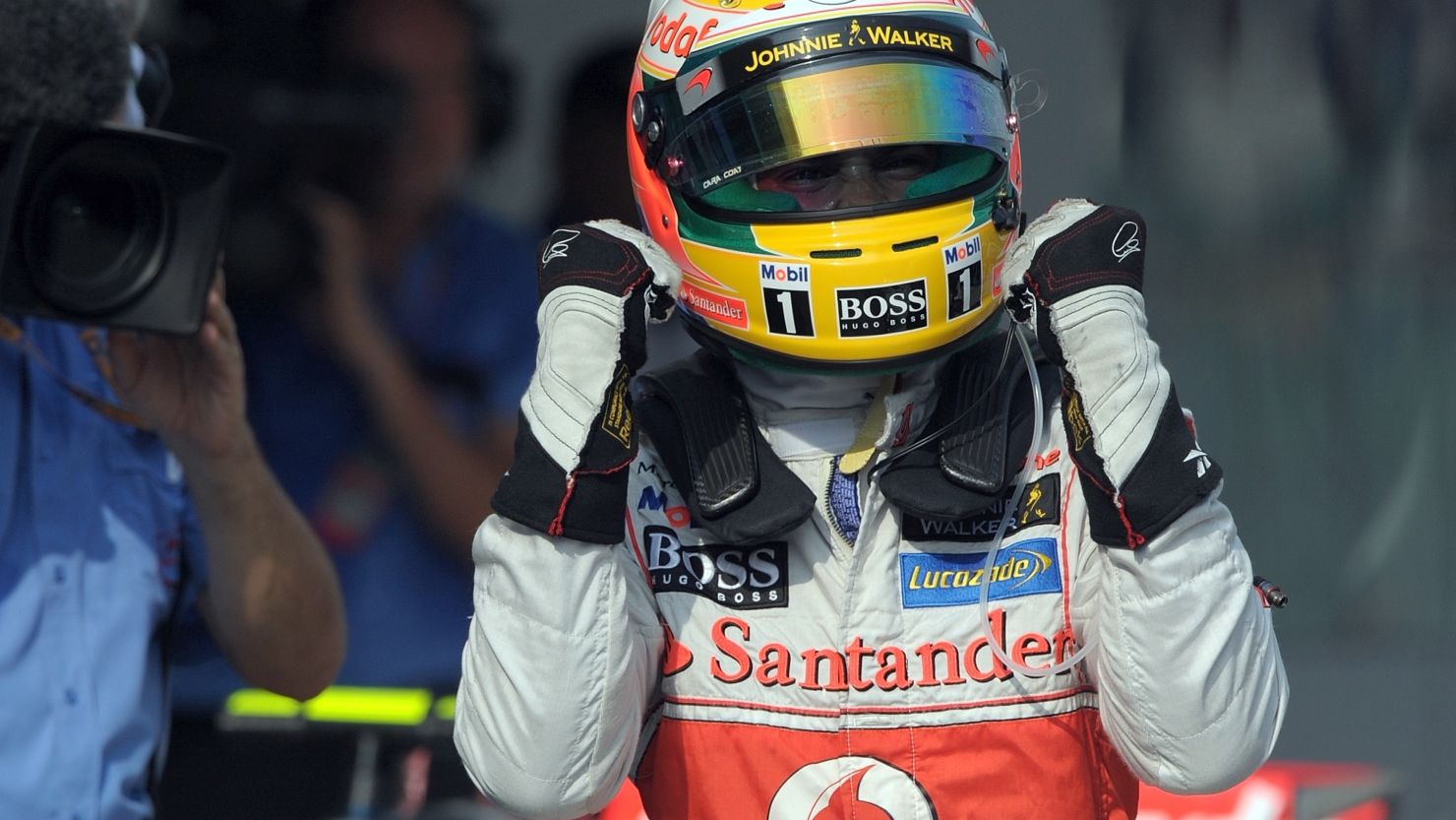 A jubilant Lewis Hamilton celebrates his pole position at Sepang for the Malaysian Grand Prix.