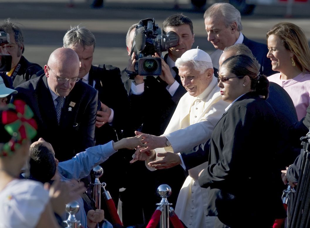 The pope greets a child upon his arrival at the Guanajuato airport.