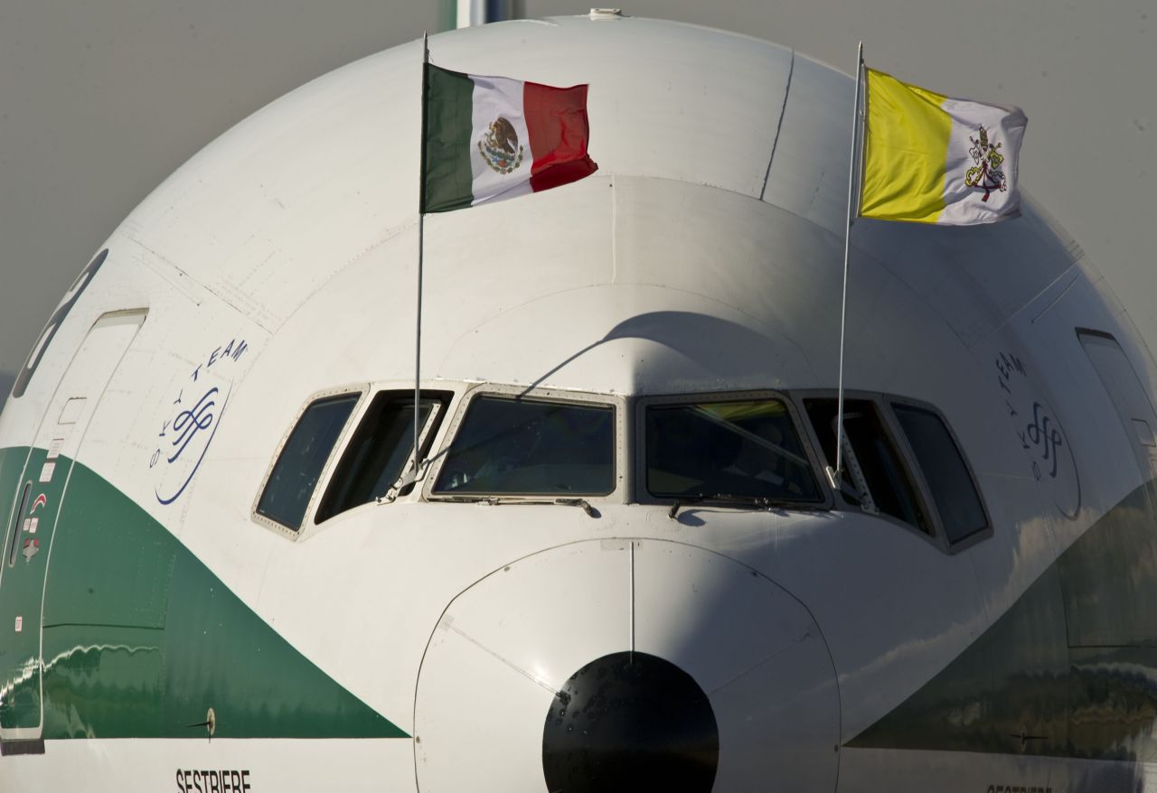 The airplane carrying Pope Benedict XVI, decorated with Mexican and Vatican flags, arrives on Saturday at Silao's international airport.