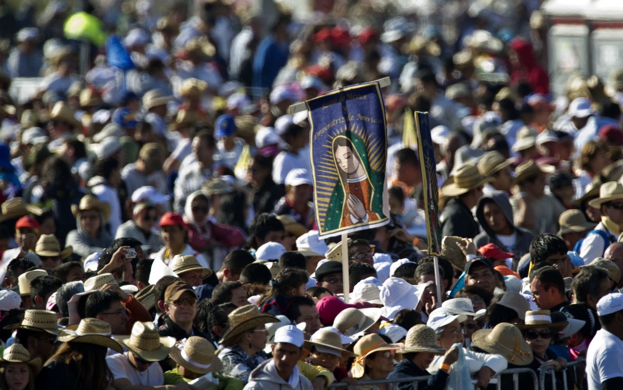 Pilgrims wait for Benedict to arrive at the park on Sunday for the Mass. Many said they had spent the night camped out, awaiting the pope's arrival.