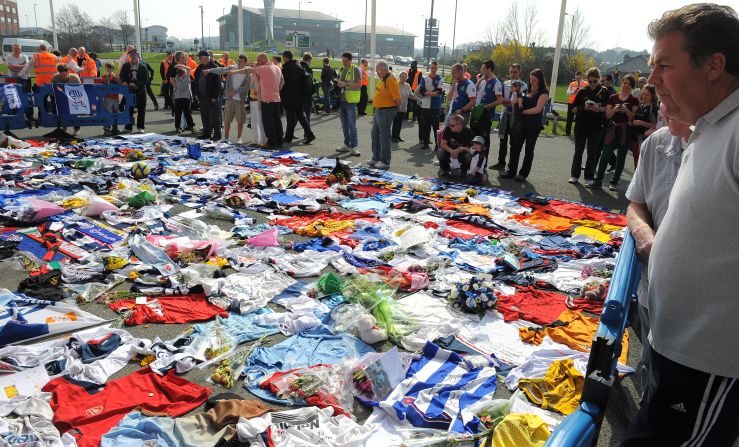 Fans of Bolton Wanderers and a host of other football clubs lay shirts outside of the Reebok Stadium in a show of support for Fabrice Muamba.