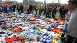 Fans of Bolton Wanderers and a host of other football clubs lay shirts outside of the Reebok Stadium in a show of support for Fabrice Muamba.