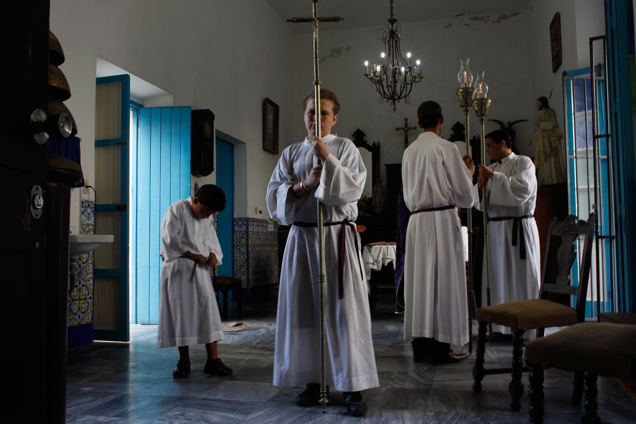 Altar boys prepare for the start of a morning service at Santo Angel Custodio church a day before Pope Benedict XVI is scheduled to arrive in Cuba on Monday. 