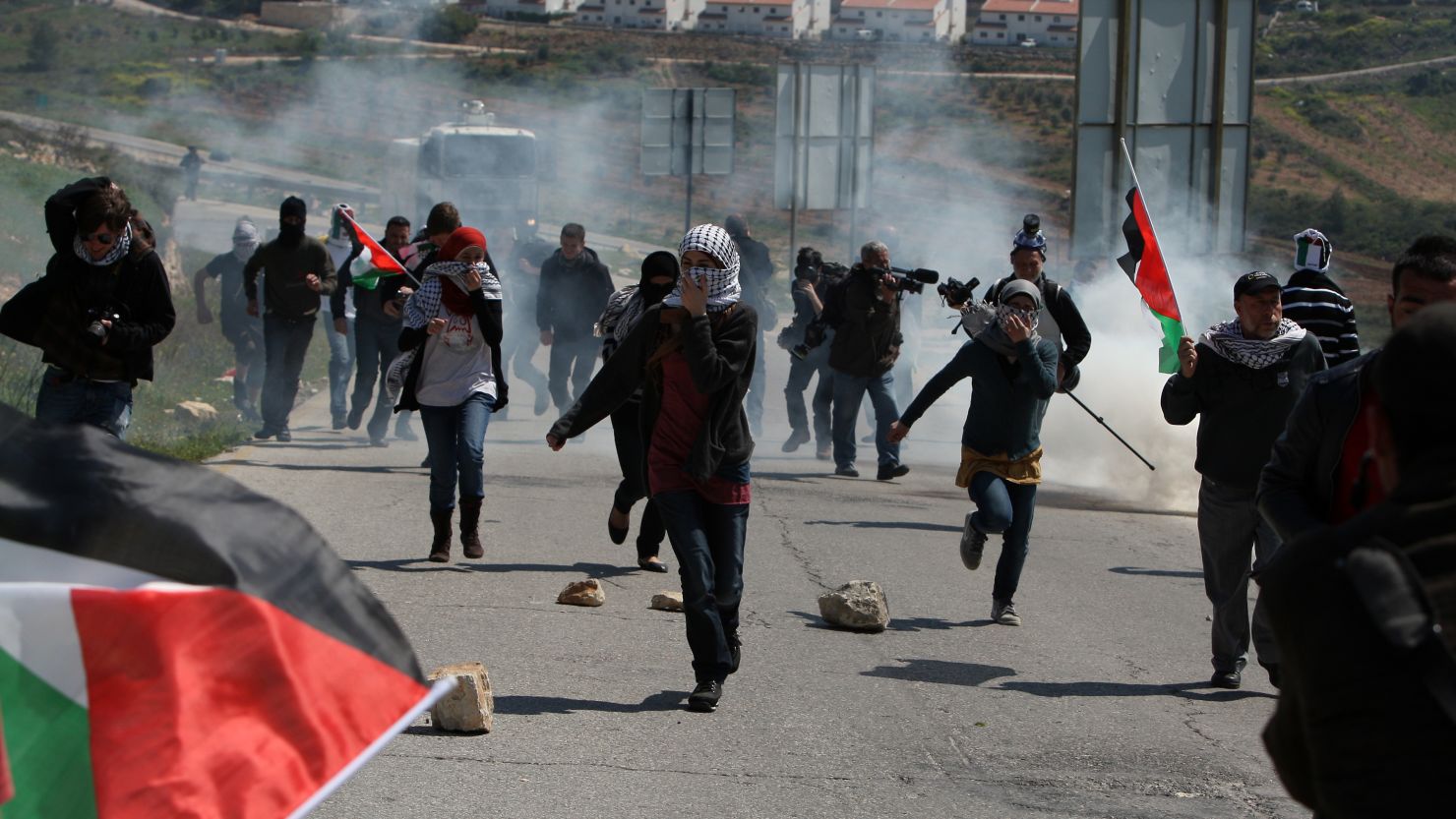 Tear gas on Friday scatters Palestinians protesting the seizure of land for a Jewish settlement near Ramallah in the West Bank.