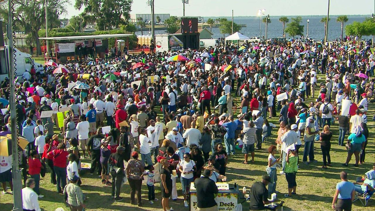 Hundreds of people gather at a park in Sanford, Florida, for a town hall meeting on the shooting of an unarmed youth.