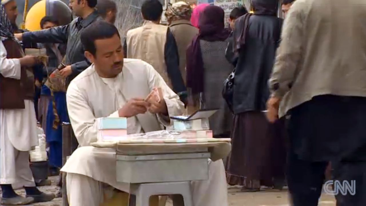 Currency is bought and sold at open-air markets in Afghanistan.