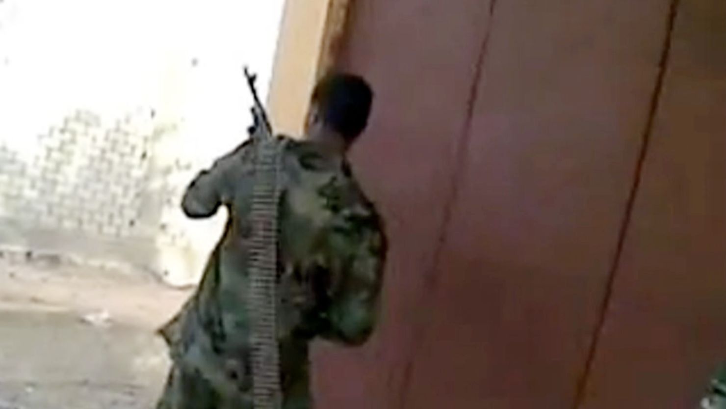 A YouTube video purported to be from Sabha, Libya, shows men shooting from behind a corner.