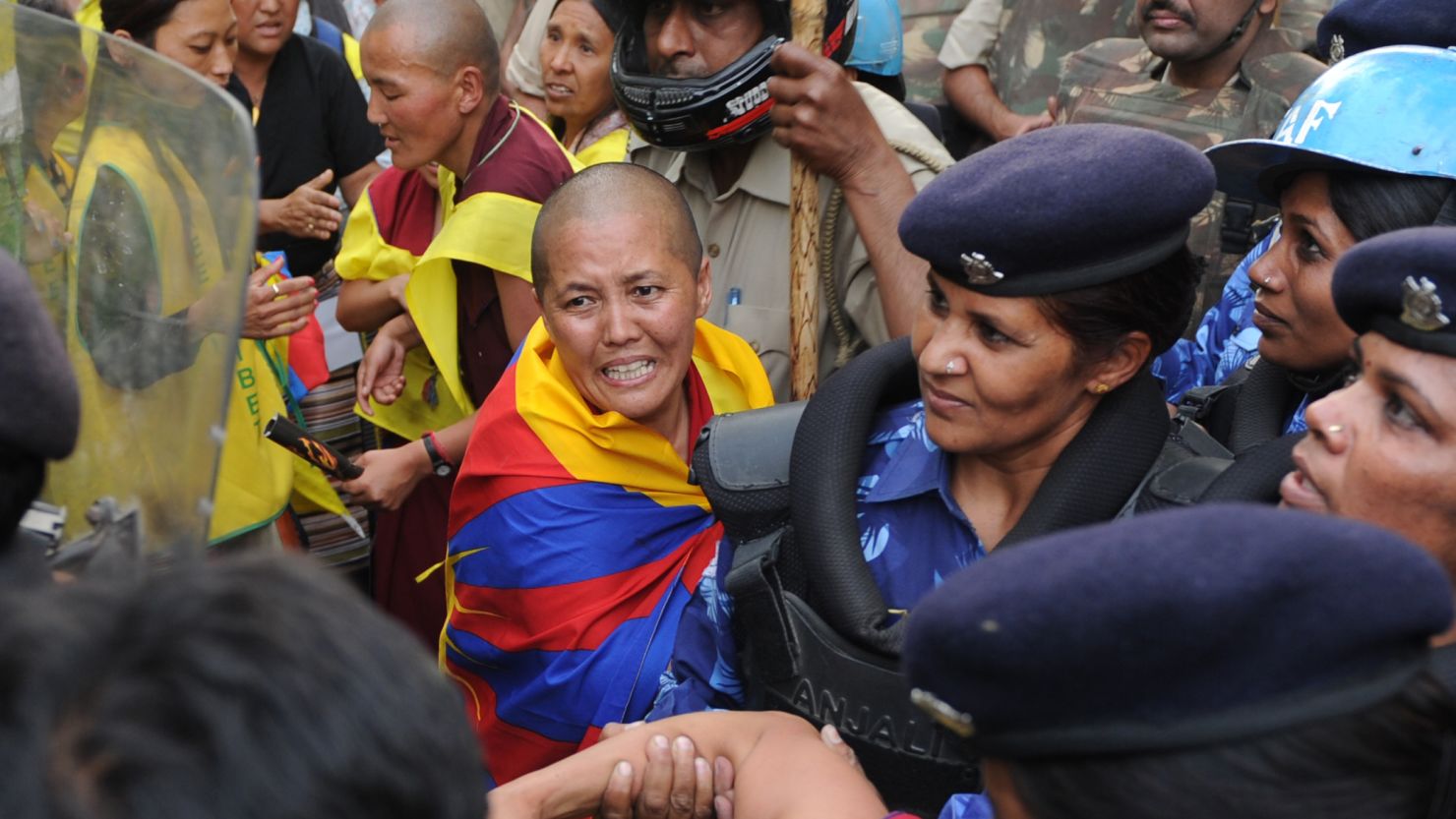 Indian police personnel pushed detained Tibetan protestors onto a bus during a demonstration in New Delhi on March 26. 
