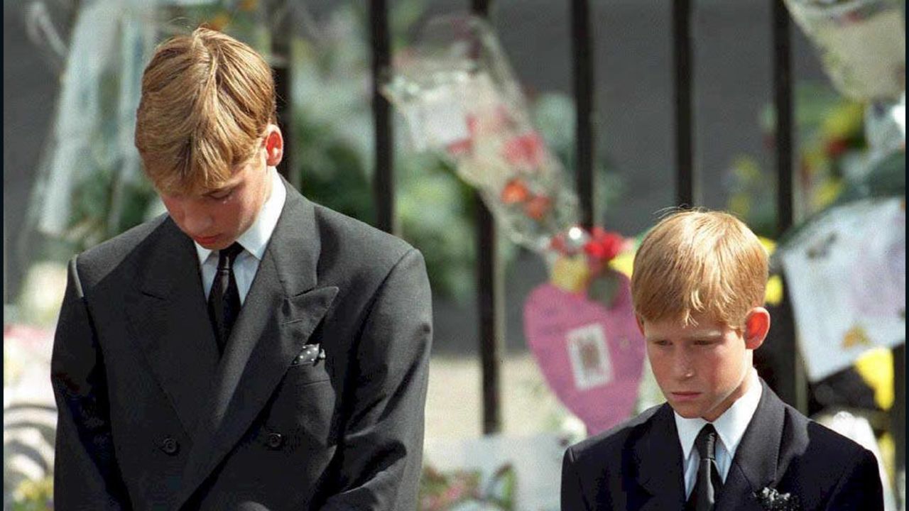 Prince William, left, and Prince Harry bow their heads as their mother's coffin is carried out of Westminster Abbey in September 1997.