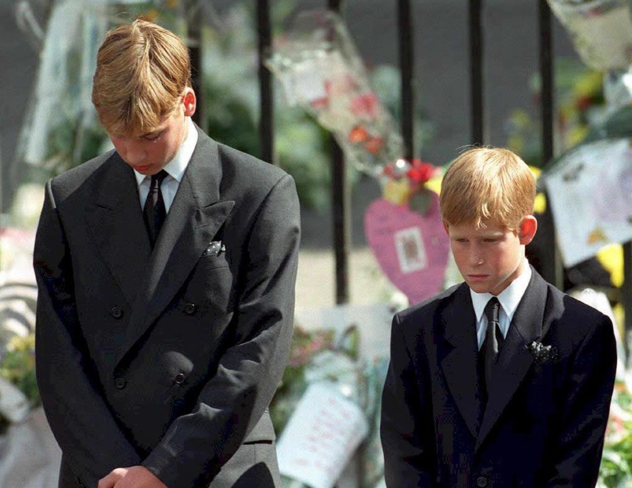 September 1997: Prince William and Prince Harry bow their heads as the coffin carrying their mother Diana is taken out of Westminster Abbey.