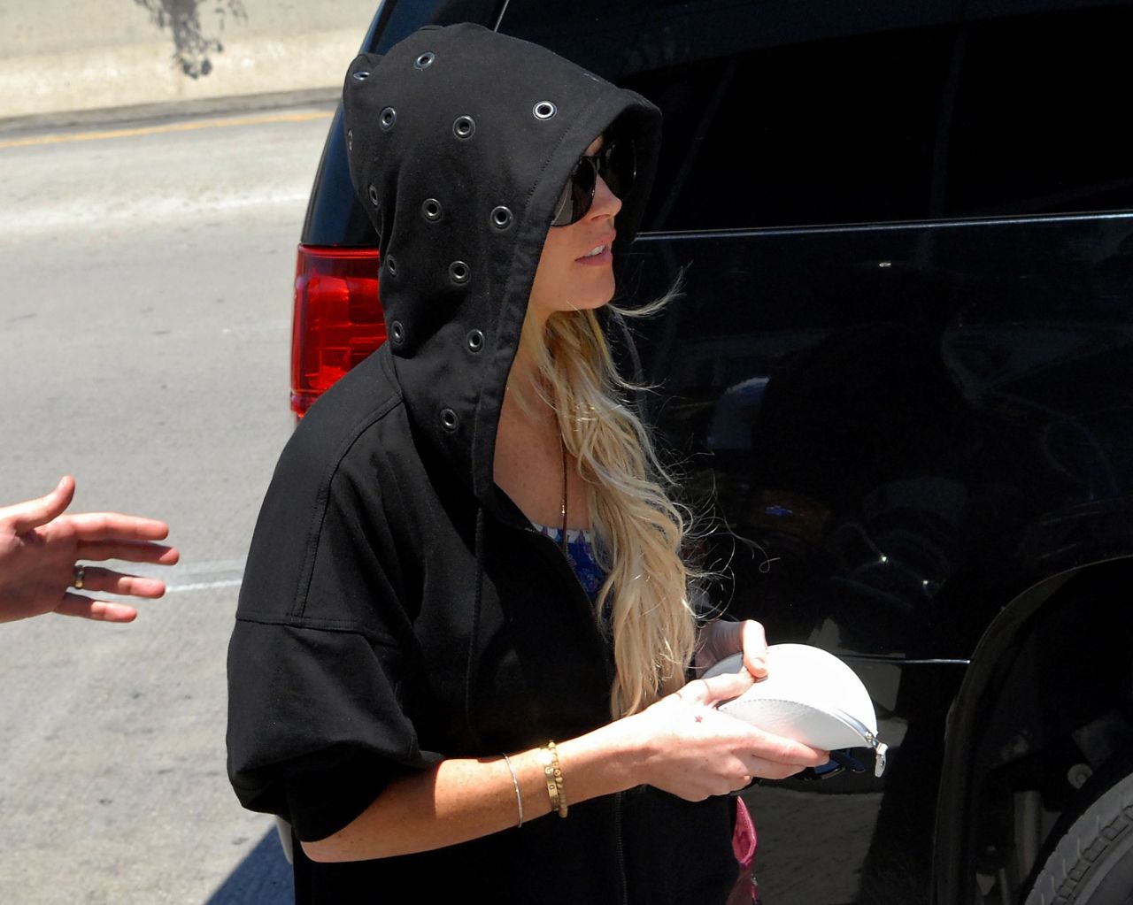 Actress Lindsay Lohan arrives at Los Angeles International Airport in a hoodie in August 2009.